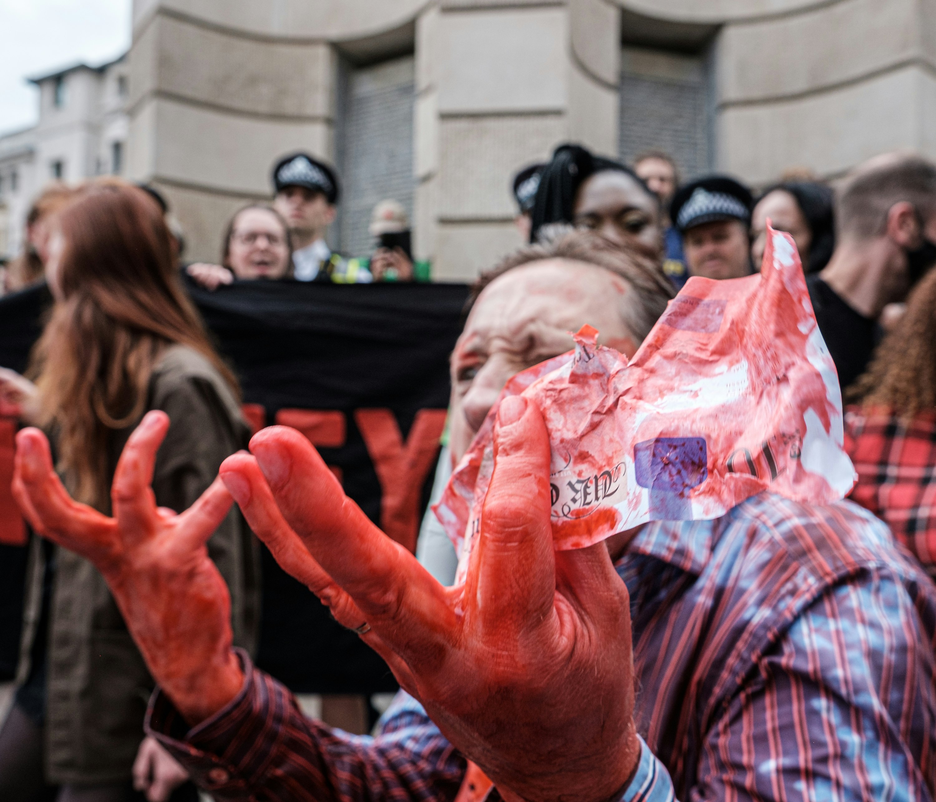 people in red white and blue plaid shirt holding pink plastic bags